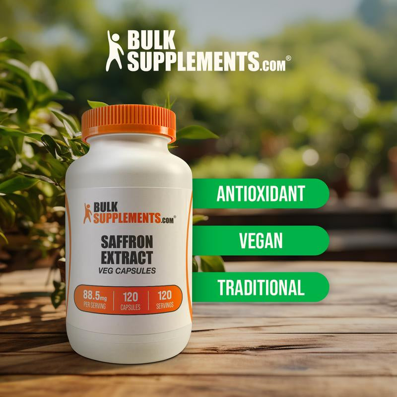 BulkSupplements white bottle of saffron extract capsules 120 count on wooden table with green plants