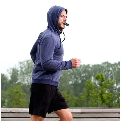 Man jogging outdoors in hoodie using HealthyRealLife sports breathing trainer mouth device to improve running endurance