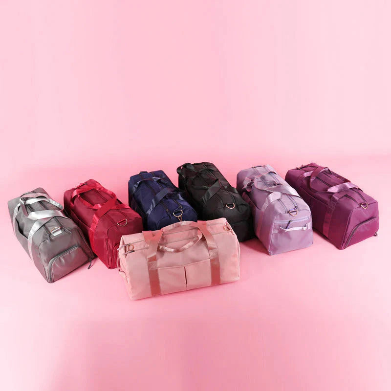 HealthyRealLife waterproof fitness duffel bag in multiple colors displayed on pink background with shoulder strap