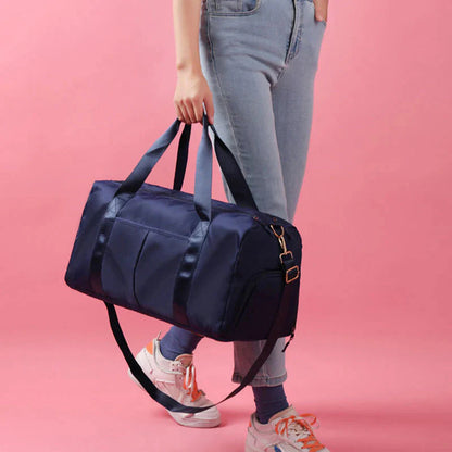 HealthyRealLife navy waterproof fitness duffel bag carried by person with adjustable shoulder strap