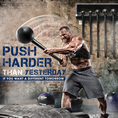 Muscular man swinging a HealthyRealLife steel mace bell for strength training in gritty gym with wall rack and tires